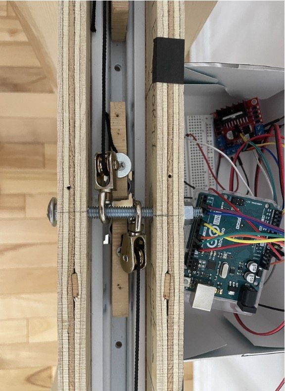 Photo of the physical prototype under construction, showing rails, pulleys and the Arduino control board